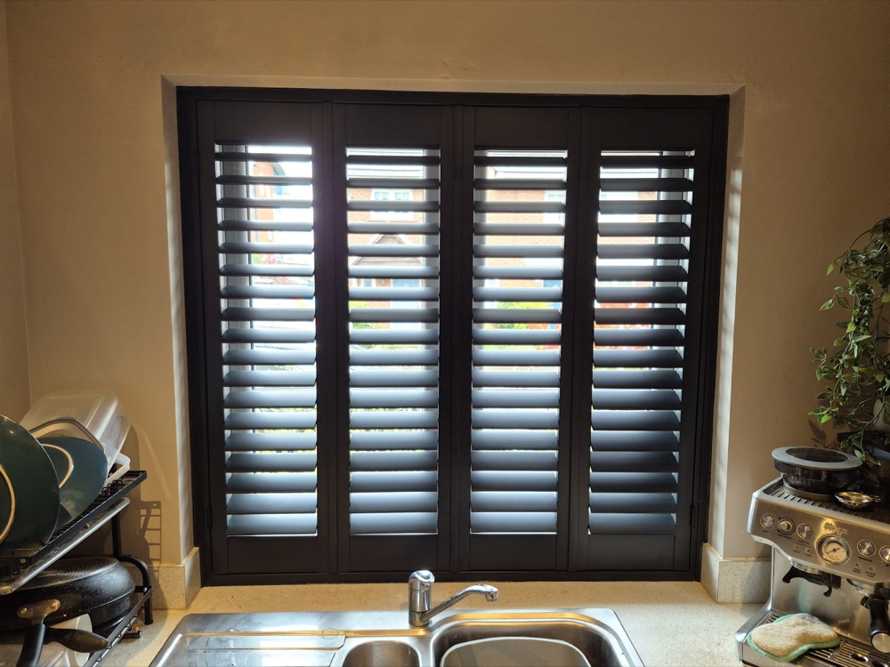 Dark shutters fitted above a kitchen sink
